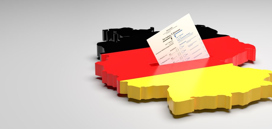 Elections in Germany. A sample ballot paper for the election to the Bundestag in the slit of a ballot box in the form of the German map with the German flag. 3d render, gray background, copy space