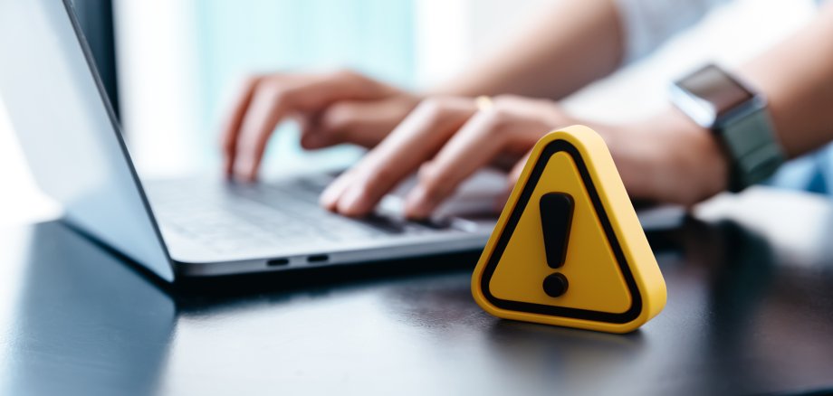 Warning sign placed on a table while businesswoman work.