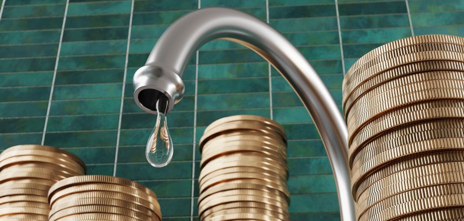 Water droplet dripping from a kitchen water tap surrounded by stacks of gold coins with green rectangular tiles as background. Illustration of the relationship between pipe leakage and money