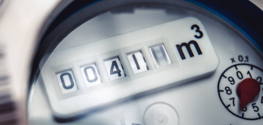 Close up of water meter with rotating digit.